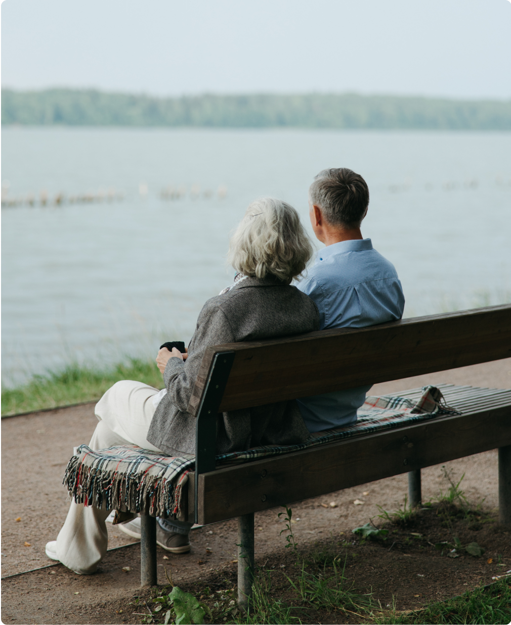 Couple sitting on a bench overlooking water
