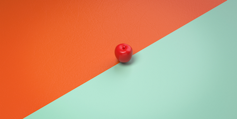 An apple between 2 coloured backgrounds